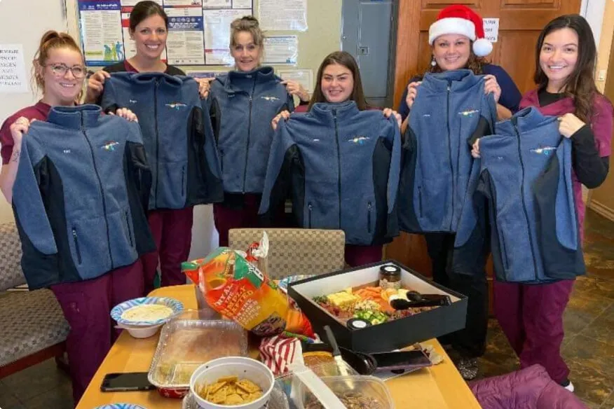 Four Seasons Dental team showing off their new uniforms.