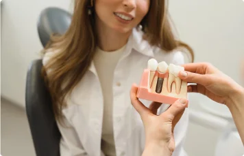 Dentist explaining a dental implant procedure to a patient at Four Seasons Dental.