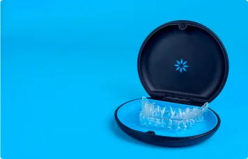 Invisalign clear aligners for teeth straightening in their packaging.